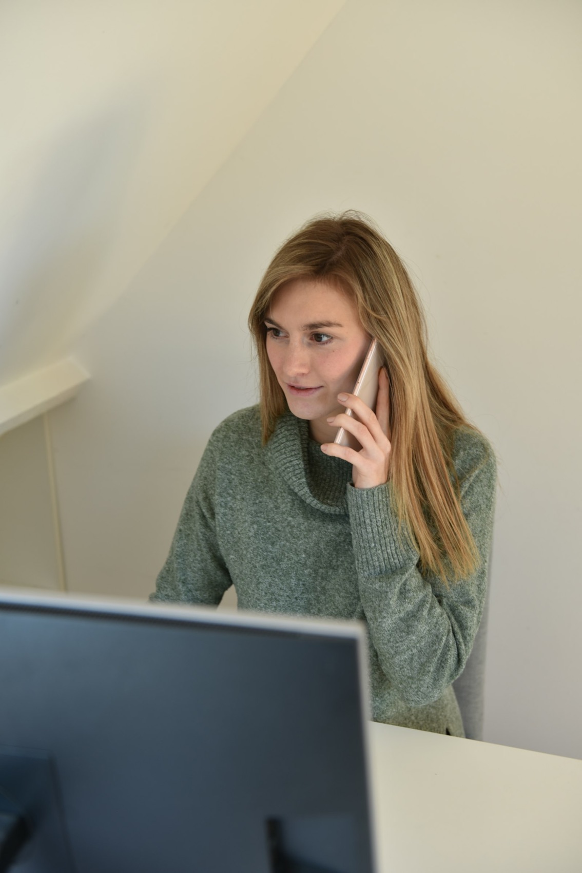 A woman on a phone call at home, smiling